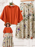 EMERY ROSE Conjunto de 2 piezas talla grande para mujer: Blusa de manga murciélago de unicolor y falda con estampado floral.